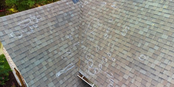 Roo0f with hail damage and chalk markings from inspection